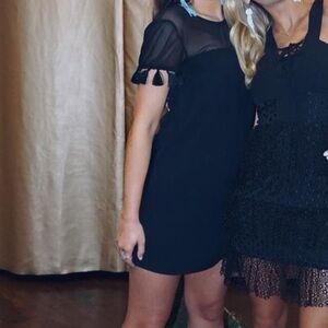 Mesh black dress with tassels in sleeves